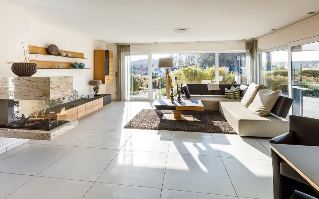 Helles, modern eingerichtetes Wohnzimmer mit großen Fenstern.