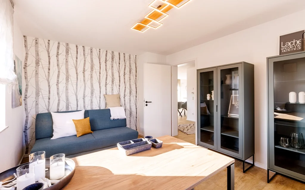 Wohnzimmer mit Sofa und Vitrine.