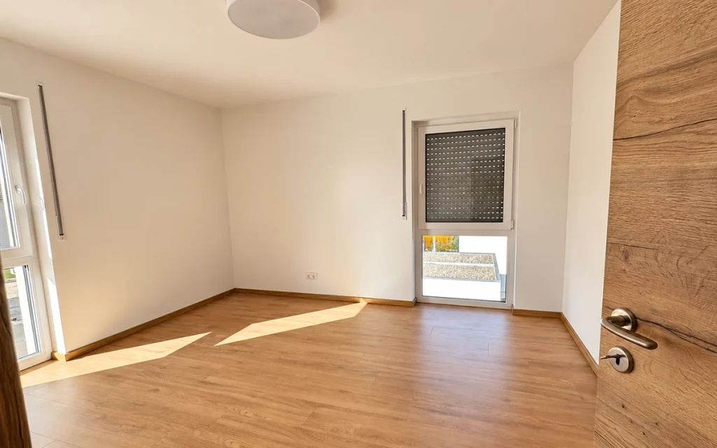 Helles Kinderzimmer mit bodentiefem Fenster und Holzfußboden
